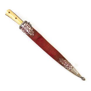 KARD DAGGER WITH SCABBARD, TURKEY, 19TH C.: Fine Damascus blade with gold inlay and Arabic religious inscriptions. Wooden sheath wrapped in original red velvet. The scabbard is mounted in fine pierced silver throat and chape. * Please review Te