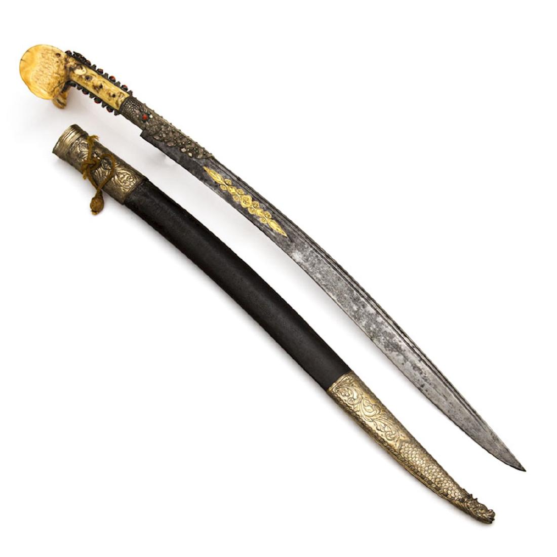 TURKISH YATAGAN SWORD WITH GOLD INLAY: Sword Yataghan, Turkey. The blade has fine gold inlay work on both sides. Including gold inlaid date in Arabic 1232 (A-H) – 1766 A.D. Large eared hilt with niello work and coral stones. Wooden scabb