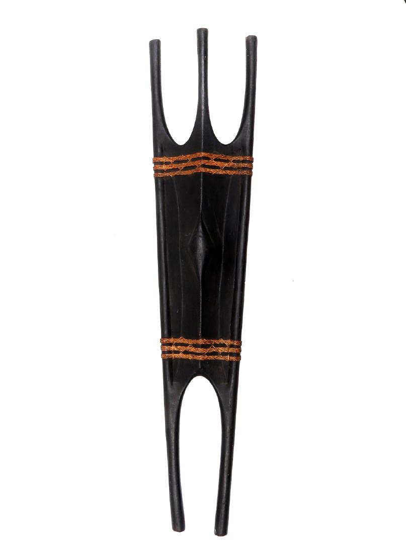 IGOROT SHIELD, KALINGA TRIBE (IGOROT), LUZON ISLAND: Wooden shield carried for protection during warfare. Mound shaped and forked with three prongs at the top and two prongs at the base. Rattan basketry was woven near the prongs to reinforce the wood. T