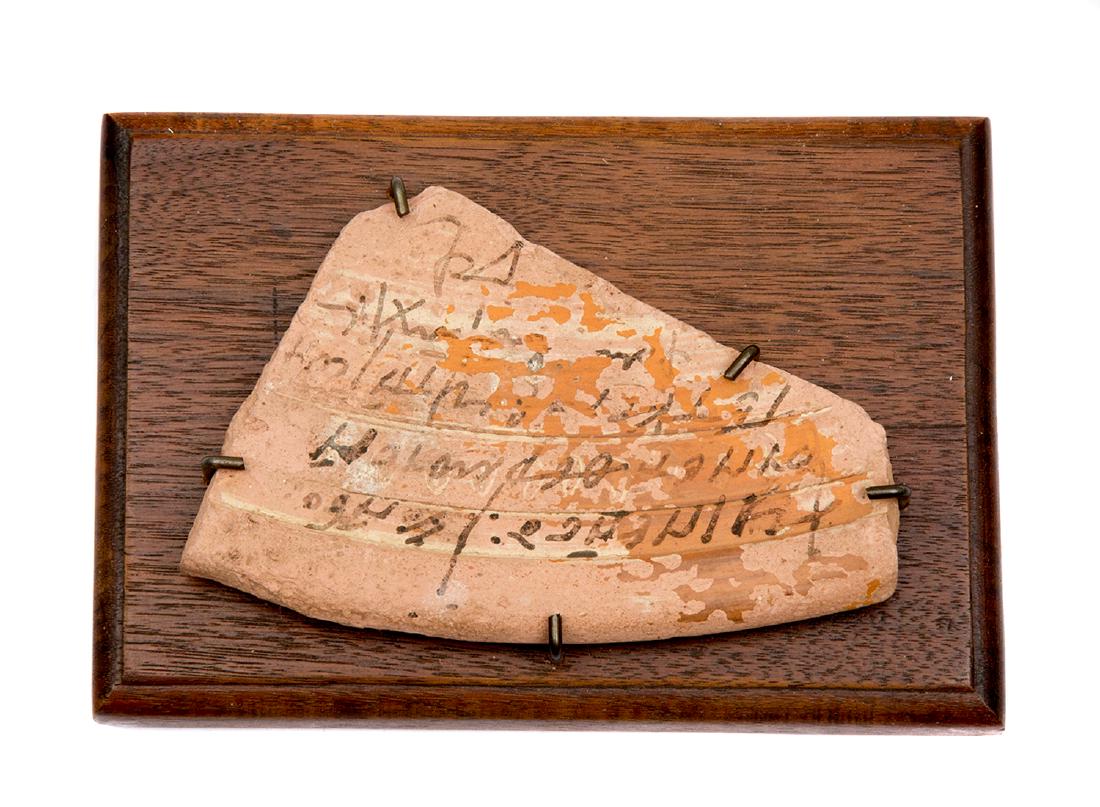 EGYPTIAN POTSHERD OSTRACA WITH DORIC SCRIPT, 300 BC: Mounted Egyptian pottery sherd with Doric script, ca. 300 BC. Provenance: Collection of Edward Frey, the author of The Kris: Mystic Weapon of the Malay World (Images of Asia). Dimensions: 5 x 3 1/4 in