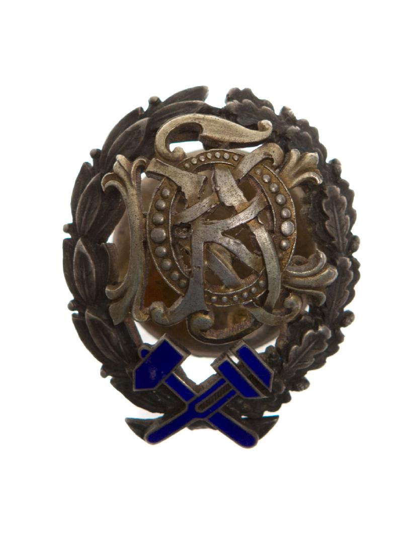 EARLY SOVIET SILVER AND ENAMEL TECHNICAL COLLEGE BADGE: The badge is made of silver with enamel. On the back it has the Russian inscription "Ivan Vasilyev" and the date July 21, 1929. Screw back. L: 1 1/2 in., (38 mm.)