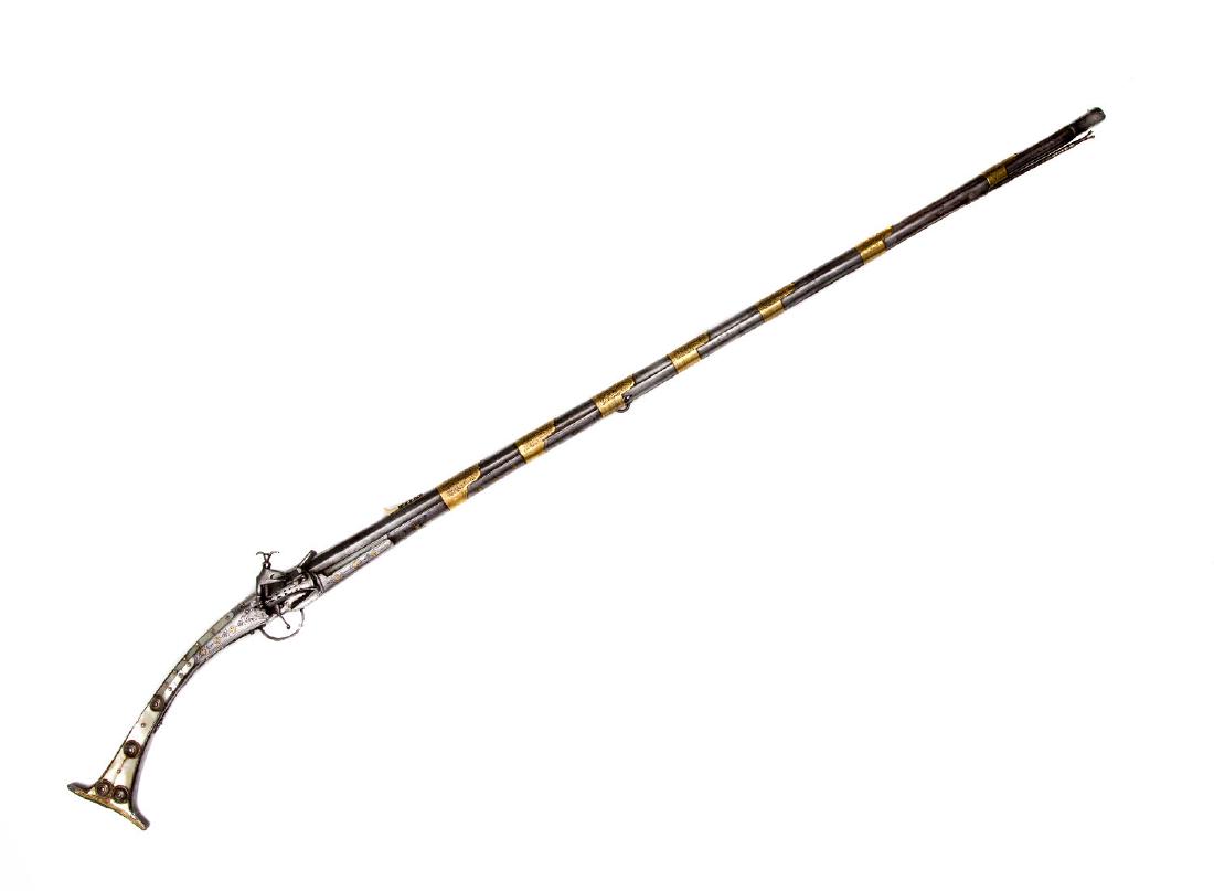 BALKAN OTTOMAN MUSKET WITH MOTHER OF PEARL, 19TH CEN.: Long beautiful well decorated Balkan (Albanian) miquelet rifle with stock enriched with mother of pearl. Steel lock plates and brass fittings are decorated with engraving. Ca. 1850. L: 57 in., (145 cm