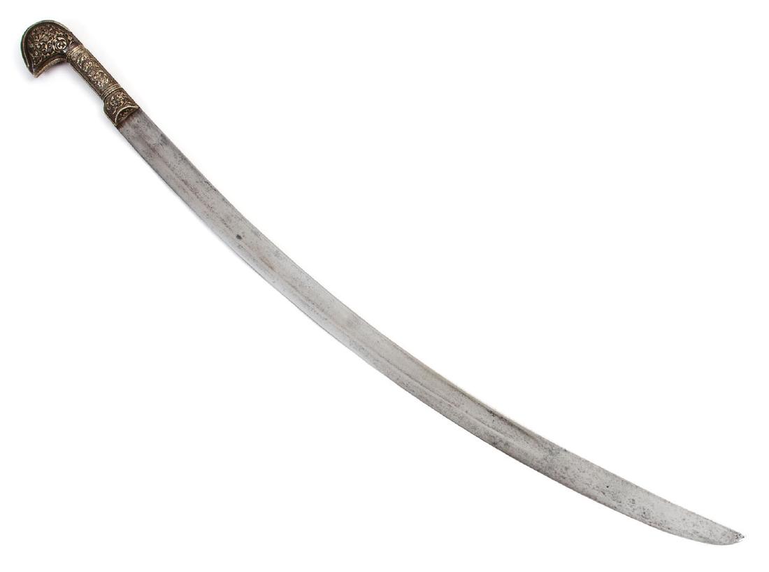 SILVER HILTED CAUCASIAN SHASHKA SWORD, 18 C.: Large silver pommel decorated with deep engraving finished with niello, 18th century European blade etching at the forte on both sides, without scabbard. L: 36 in., (96 cm.)