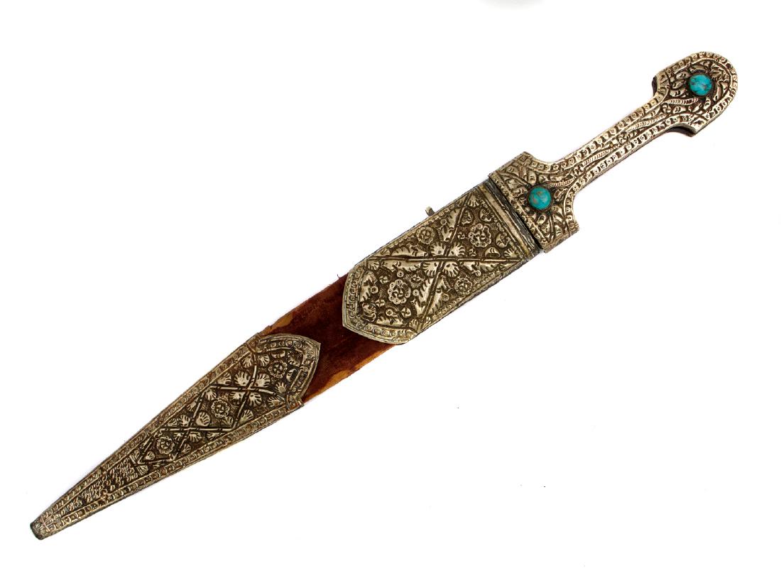 PERSIAN KINJAL DAGGER IN SILVER MOUNTS, 19TH C.: Persian dagger with double edged blade covered with etched Arabic inscriptions on one side. Low grade embossed silver mounts and hilt decorated with floral motif. The hilt is mounted with two turquois
