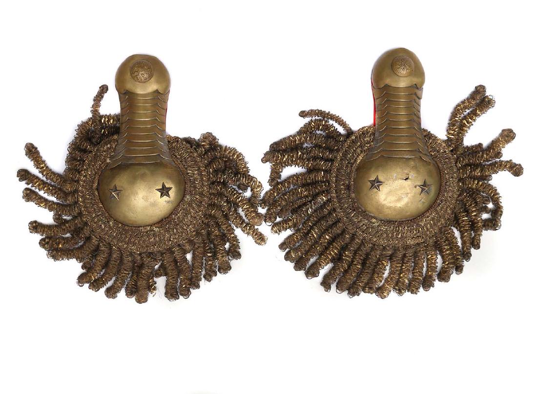 RUSSIAN IMPERIAL GENERAL SHOULDER BOARDS: A rare complete pair of Russian Imperial general epaulettes of Cavalry maid of gilt brass base and figured scales, increasing in size from the spine to the rounded cup. With red cloth liner. Ca. 1900.