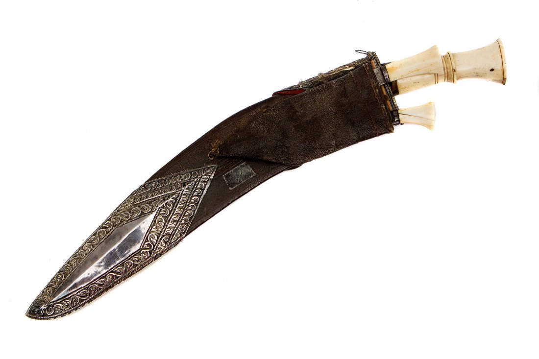 KUKRI KNIFE, NEPAL WITH SILVER GILT MOUNTS, 19TH C.: Repousse silver mounted scabbard with gold panel, nicely carved hilts, excellent blade with two side knives. Provenance: Collection of Edward Frey (1920-2003) Miami, Florida. Mr. Frey was a known coll