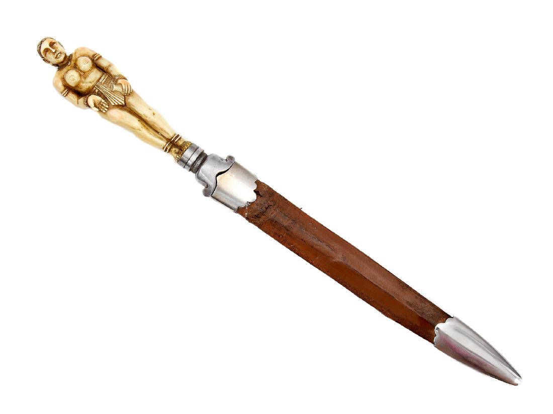 AN INDIAN DAGGER WITH GOA HILT, 18TH C.: An Indian dagger with figural hilt Goa. Straight double edged blade with two deep fullers separated in the lower half by a third fuller. Steel bolster block with small scrolled quillons. Grip carved a