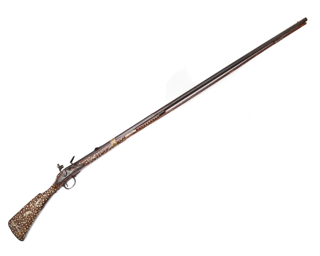NORTHERN ITALY FLINTLOCK BIRD GUN: Flintlock gun, with steel unmarked lock, 1/3 of the barrel is octagonal shape, wooden stock decorated with bone inlay and brass ornament on the rib and left side, and steel butt plate. Few cracks in t