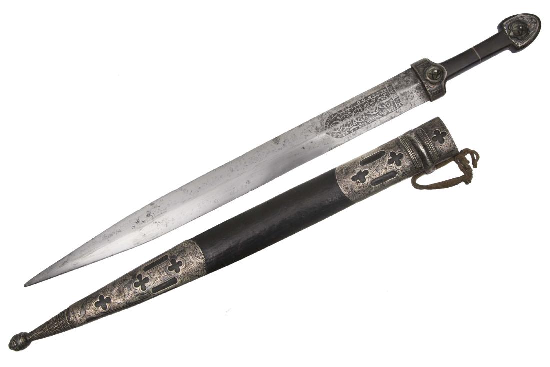 CAUCASIAN CHECHEN KAMA DAGGER WITH ZHAMAL BLADE: Large kama with horn hilt mounted in nielloed silver, diamond-shaped blade decorated with etching at forte and marked of "ZHAMAL" (in Cyrilic), wooden scabbard wrapped in black leather with nielloed s