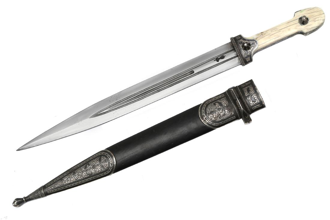 CAUCASIAN DAGESTAN ISLAMIC DAGGER: Of characteristic form with razor sharp blade and elaborately engraved and nielloed silver mounts. Blade bears maker's marks. Second half 19th c. Dimensions: L: 19 3/8 in., (49.5 cm.)