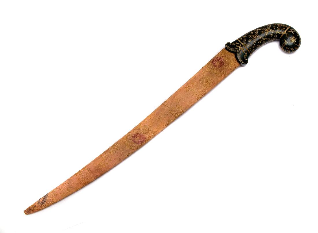 INDIAN MUGHAL STYLE DAGGER WITH FLUTED BLADE: Double edged slightly curved pierced blade decorated with rich gold koftgari work. Beautifully carved jade hilt carved and gilded with floral motif. Wooden scabbard covered with fabric. Dimensions: L: