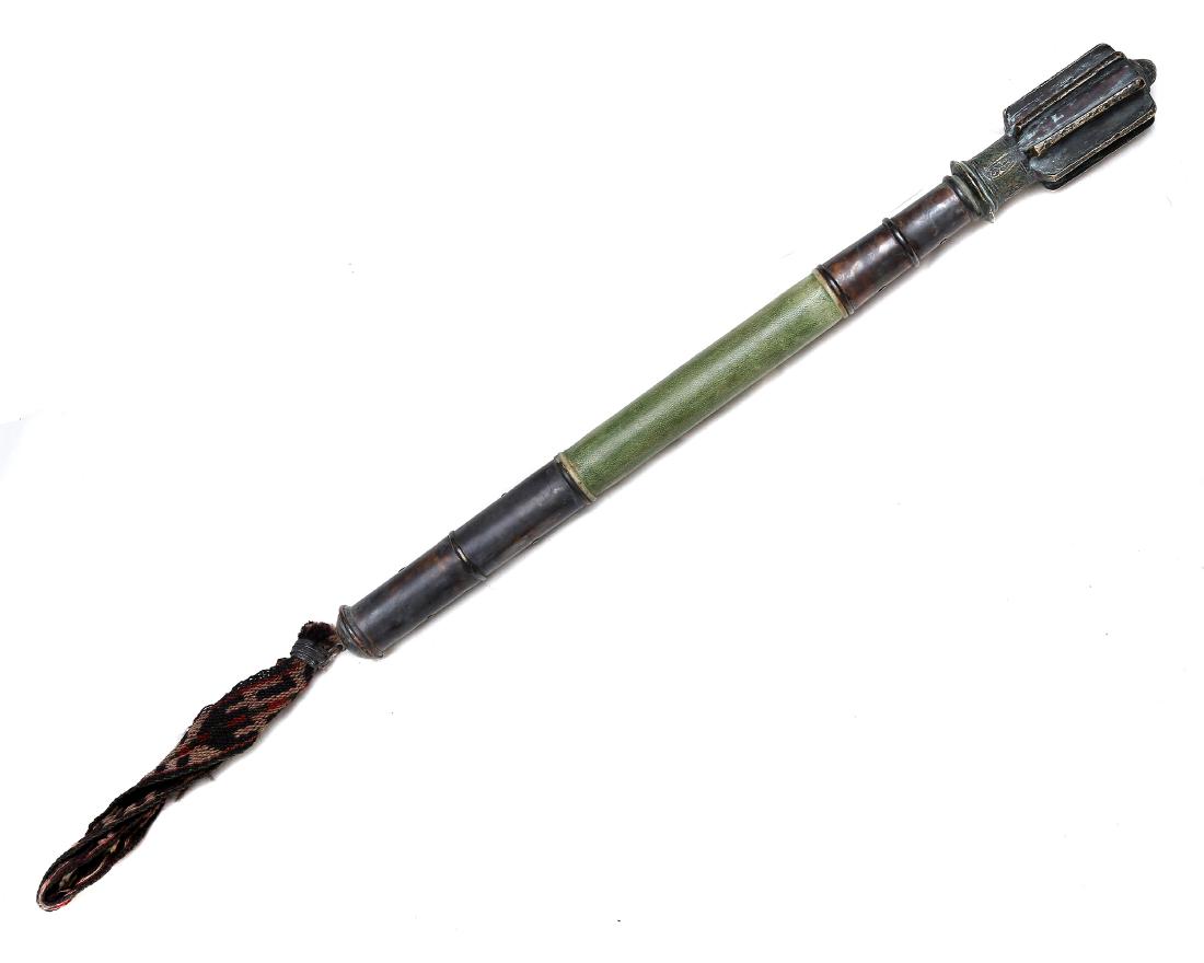 SELJUK TURKISH ISLAMIC MACE WITH A LATER SHAFT: Bronze cast war head with Arabic inscriptions, brass mounted shaft covered with green leather stitched with the ladder of Allah seam. Dimensions: L: 23 1/4 in., (59 cm.)