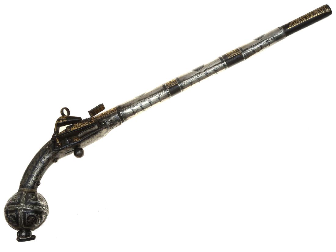 CAUCASIAN ISLAMIC SILVER MOUNTED FLINTLOCK PISTOL: Circassian flintlock silver mounted flintlock pistol richly decorated with niello and gilt, Arabic inscriptions on the barrel, working lock. 2nd half of the 19th C. Dimensions: L: 19 in., (48.3 cm.)