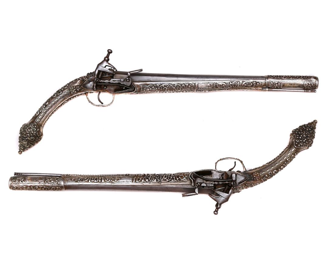 PAIR OF ISLAMIC SILVER MOUNTED GREEK PISTOLS: A pair of Islamic Ottoman Empire, Balkan, Greek or Montenegrin flintlock (miquelet) holster (KUBUR) pistols, early 19th c. each with elaborate low grade silver mounts in high relief. Excellent working