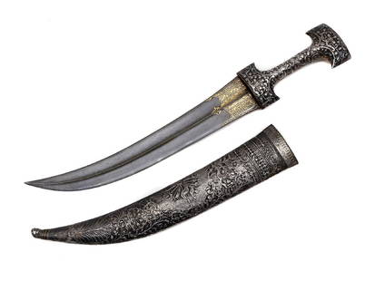 OTTOMAN TURKISH ISLAMIC JAMBIYA IN SILVER MOUNTS: A stunner jambiya dagger in fully chased silver furniture. Wide and long blade with a nice Damascus steel pattern throughout and gold inlay on ricasso. Scabbard and hilt are fully chased silver with t