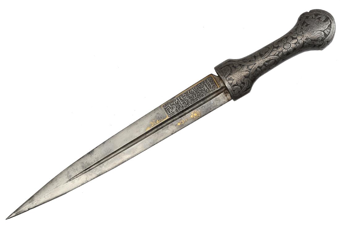PERSIAN ISLAMIC DAGGER WITH ARABIC INSCRIPTIONS: Steel hilt with chiseled floral motifs, double-edged blade with one fuller and Arabic inscriptions on both side, decorated with gold koftgari. Dimensions: L: 14 in., (35.5 cm.)