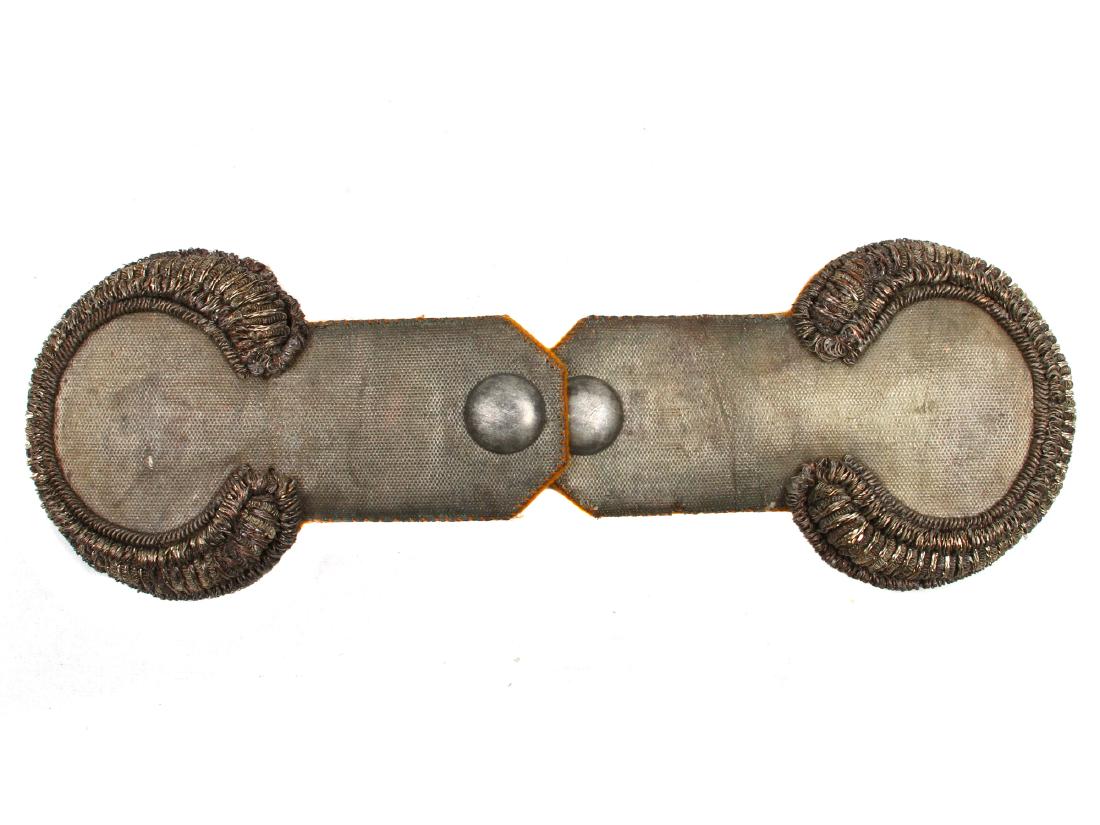 A PAIR OF RUSSIAN IMPERIAL OFFICER EPAULETTES: Shoulder pieces on a stiff frame uppers in a fine silver brocade type material and silver-colored bullion wire, underside is in orange material. Dimensions: L: 6 in., (15 cm.)