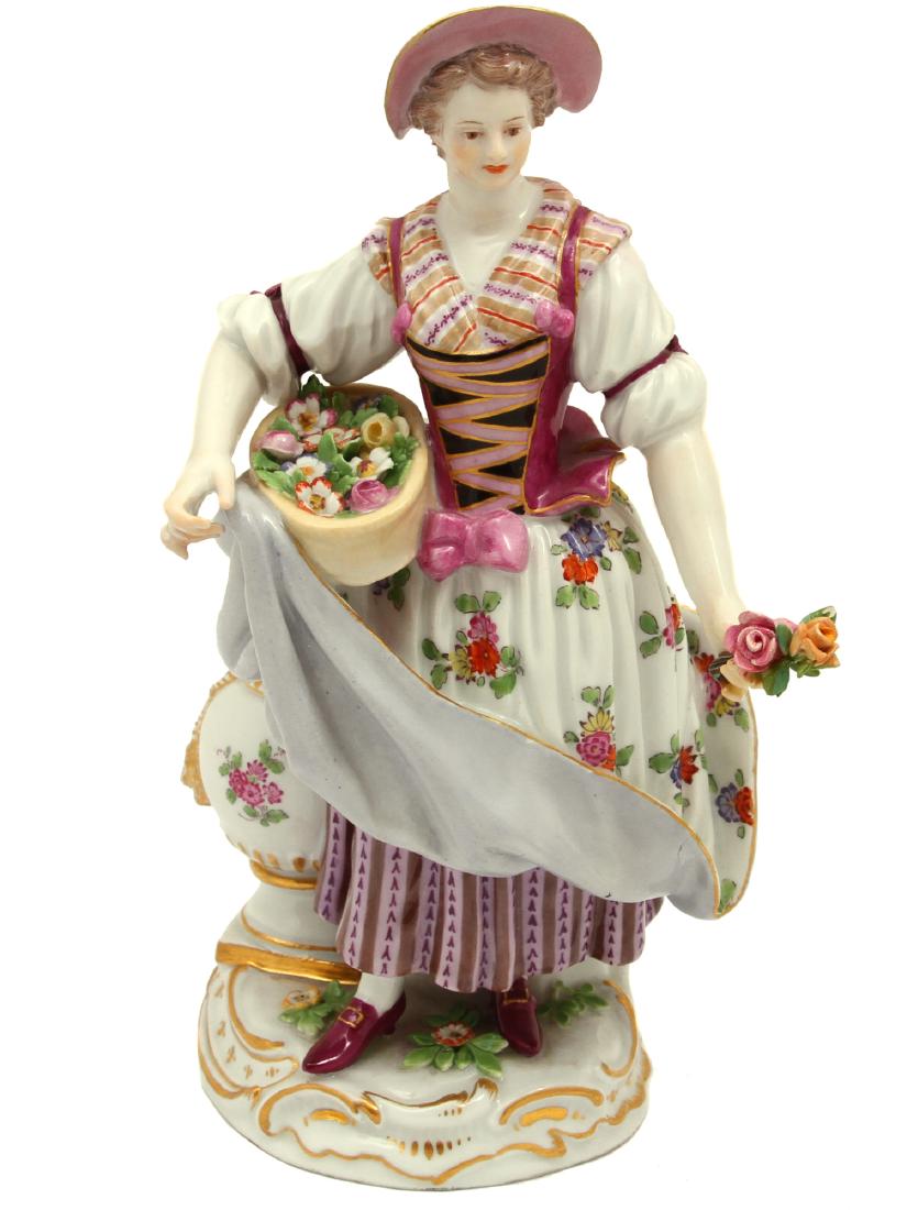A MEISSEN PORCELAIN FEMALE GARDNER FIGURINE: A Meissen figurine depicting a 'Flower Maiden', late 19th century with under glaze blue crossed swords mark, inscribed number C 68, impressed number 144. Dimensions: H: 8 in., (20 cm.)