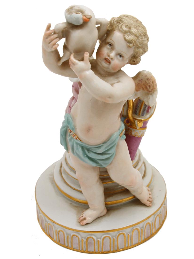 MEISSEN PORCELAIN CUPID FIGURINE HOLDING DUCK: Antique Meissen figurine of a cherub holding a duck, with underglaze blue crossed swords mark, inscribed number E. 83., impressed number 69. Dimensions: H: 7 in., (18 cm.)