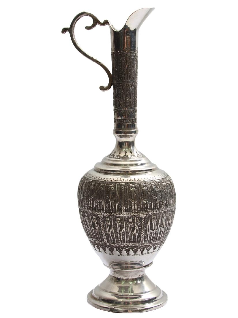 AN ELEGANT ISLAMIC PERSIAN SILVER REPOUSSE JUG: An elegant Persian ewer decorate with characteristic human figurines. Silver hallmarks: lion head (Iran), 19 - 20 cc. Weight: 9.6 oz., 272 gr. Dimensions: H: 9 1/2 in., (24 cm.)