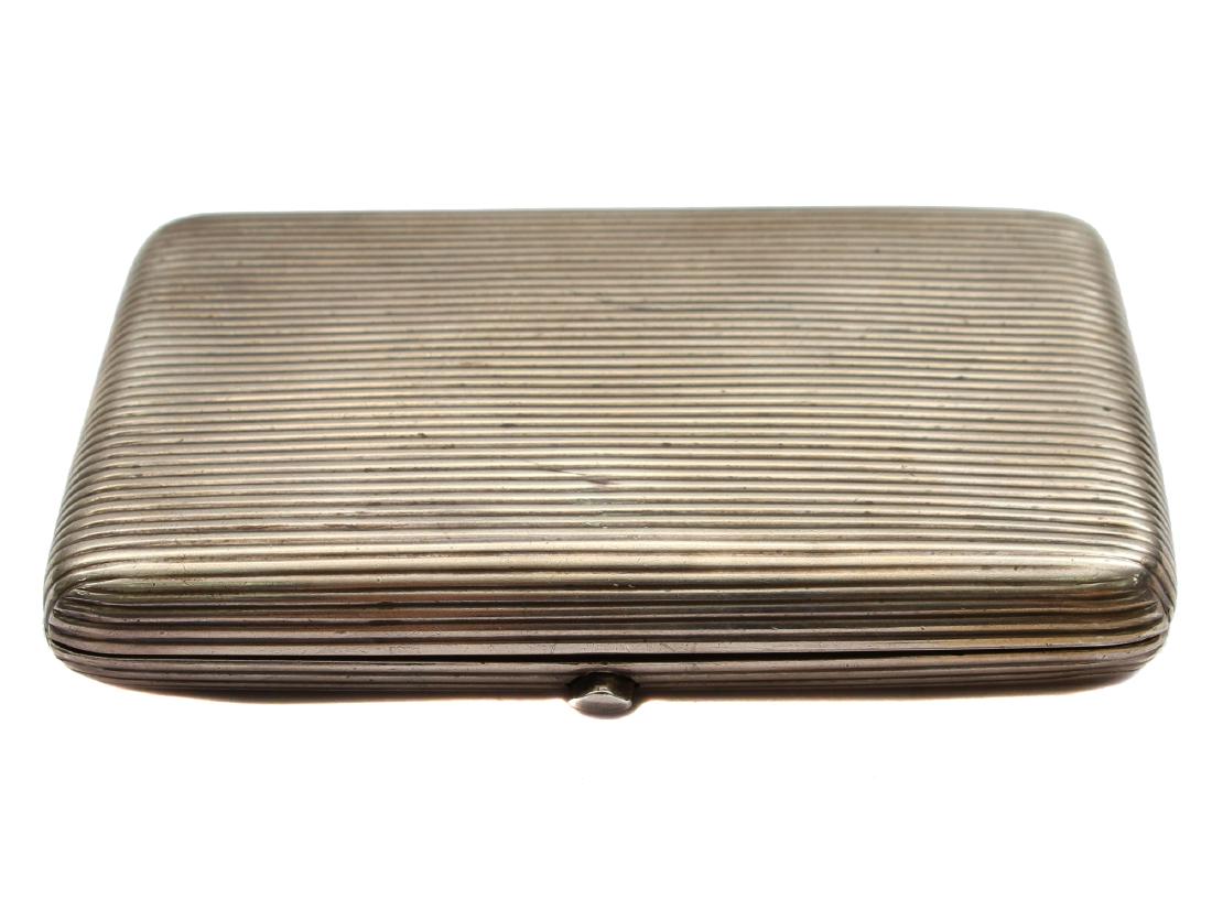 A RUSSIAN ANTIQUE SILVER GILT CIGARETTE CASE 19 C: Case with reeded covers. Push open with thumb-piece. Gilt interior. Hallmarked "A.C." (in Cyr.) and 84 silver standard on both sides of the case. Weight: 4.6 oz., 132 gr. Dimensions: 4 1/4 in., (11 cm