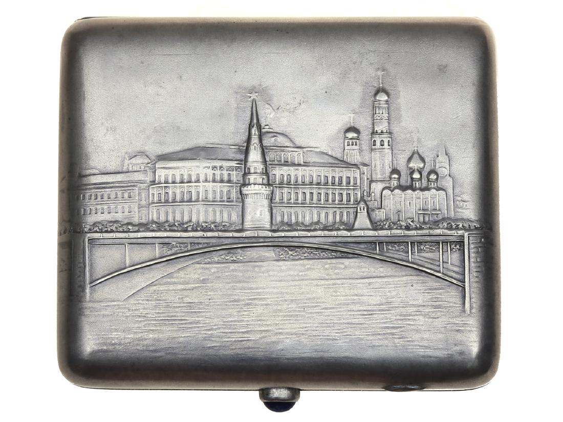 RUSSIAN KREMLIN SILVER CIGARETTE CASE WITH GEM: Soviet silver cigarette case with embossed image of Kremlin. Hallmarked: MMU (in Cyrillic), female head, 875. Total silver weight: 6.7 oz. , (190 g.) Dimensions: 4 1/8 x 3 1/2 in., ( 10.5 x 9 cm. )