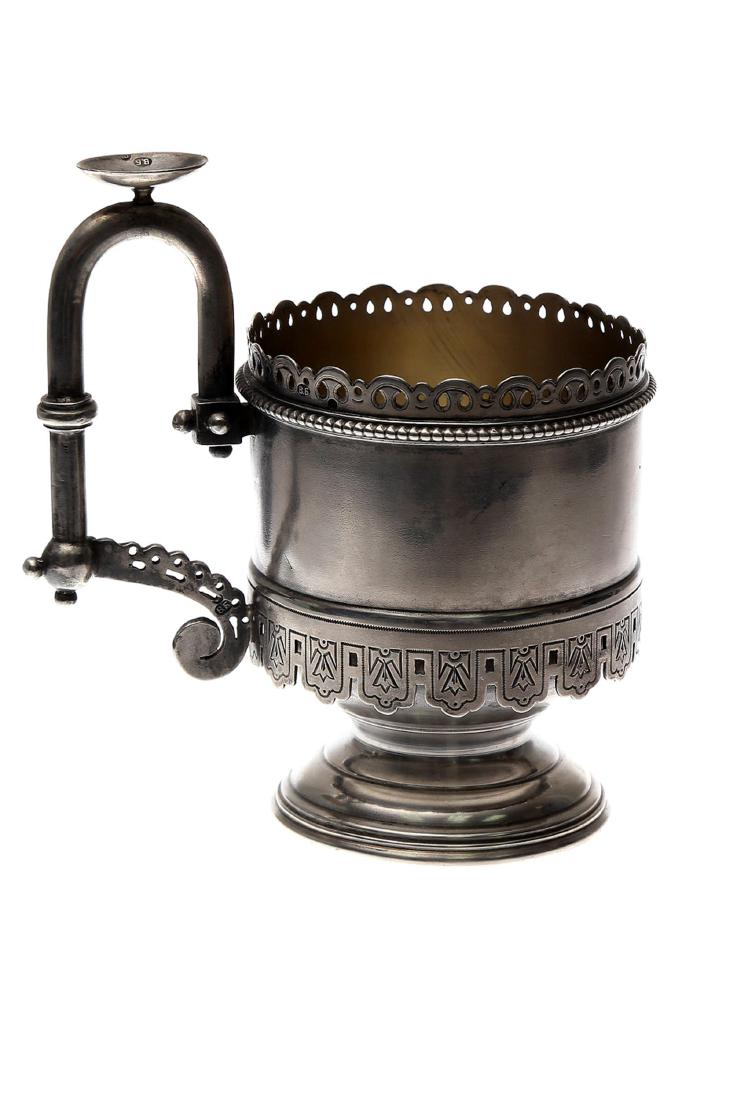IMPERIAL RUSSIAN SILVER GILT GLASS HOLDER, 19TH C.: An Imperial Russian tea glass holder in Pan Slavic style featuring gold washed inside, hallmarked "V.B." in Cyrillic on the handle and bottom and "84. Weight: 6.6 oz., (188 gr.) Dimensions: D: 2 3/4 i