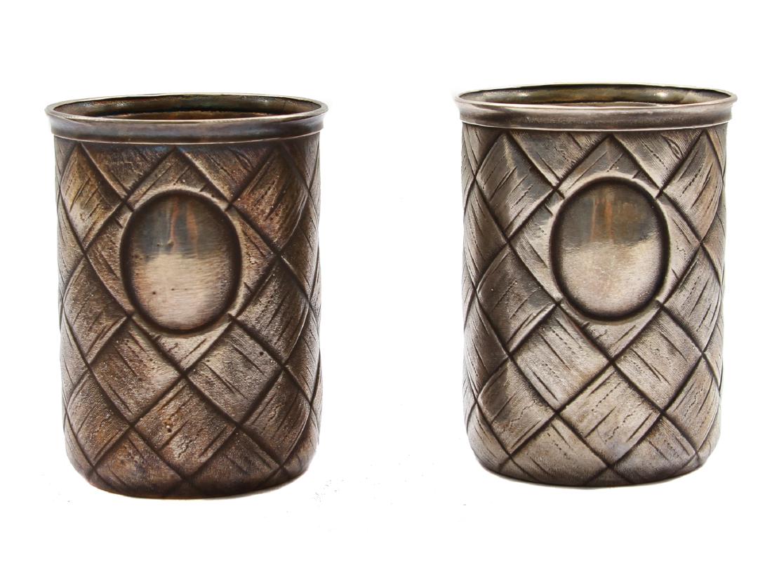 A PAIR OF ANTIQUE RUSSIAN SILVER CHARKAS: Vintage 84 standard silver pair of vodka shot cups, decorated with weave like pattern and "blank" monograms. Hallmarked on a side under the rim with "ÐŸ.Ð”." in Cyrillic and 84 silver standard. T