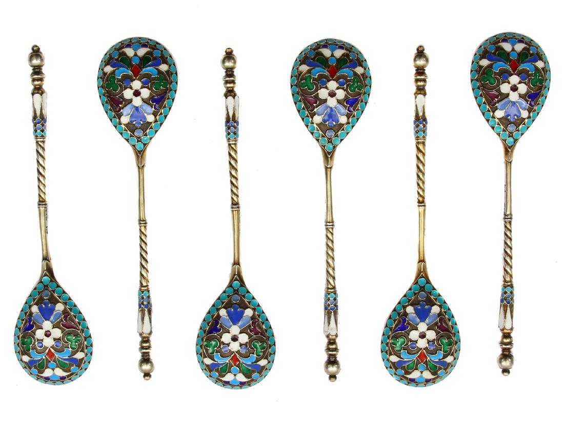 A SET OF SIX SILVER GILT AND ENAMEL SPOONS: The exterior of each fig-shaped bowl enameled with varicolored scrolling flowers on stippled gilt ground, with gilt interior, the twisted stem with baluster finial enameled with geometric motifs. Hall