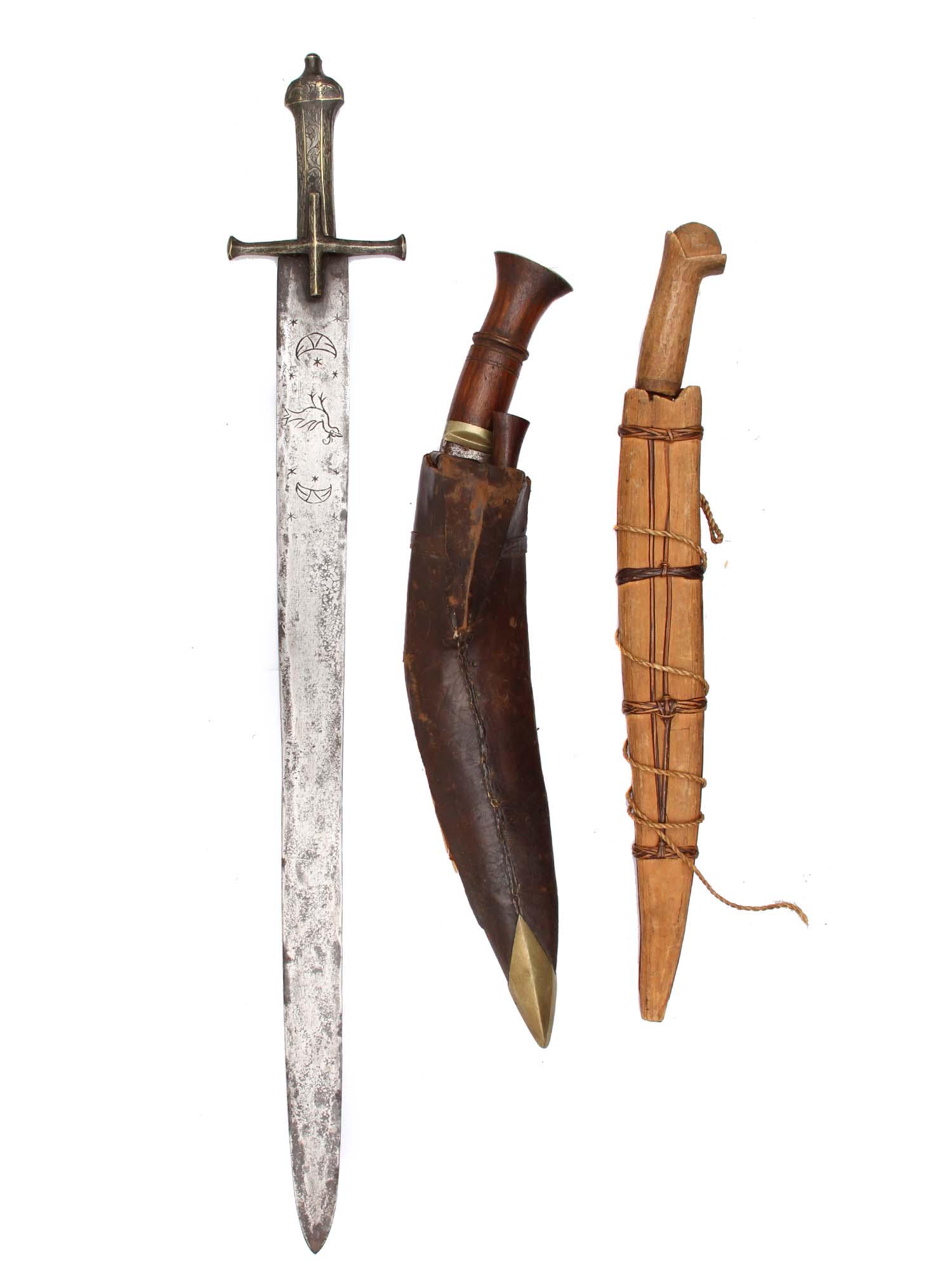 A LOT OF SWORD AND DAGGERS: (1) African kaskara sword with brass handle and cross guard, blade decorated with chiseling; (2) Nepalese kukri knife with wood handle, two small knives, scabbard is wood covered with leather and bras