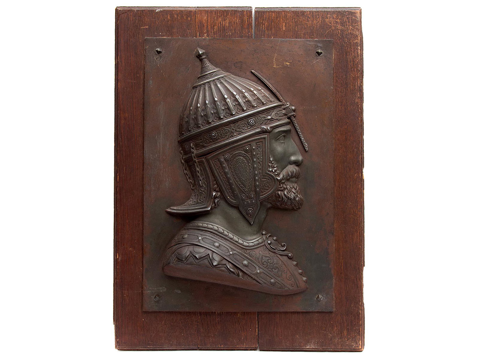 QAJAR WARRIOR METAL PLATE BY D. LENOIR, 19TH C.: A cast bronze plate relief depicting a Qajar warrior in traditional Persian helmet (khula khud). France 19th century. Signed: lower right: D. Lenoir. Dimensions: 26 1/2 x 19 in. (67 x 49 cm.)