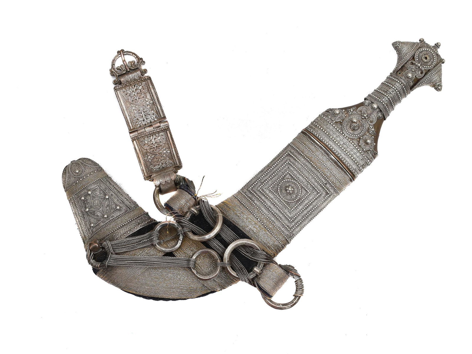 AN OMANI SILVER-MOUNTED JAMBIYA DAGGER & HANGERS: A silver-mounted Omani jambiya dagger with a characteristic curved blade with a central ridge, the silver-mounted scabbard is decorated with a beaded silver geometrical pattern. The hilt is horn, silv
