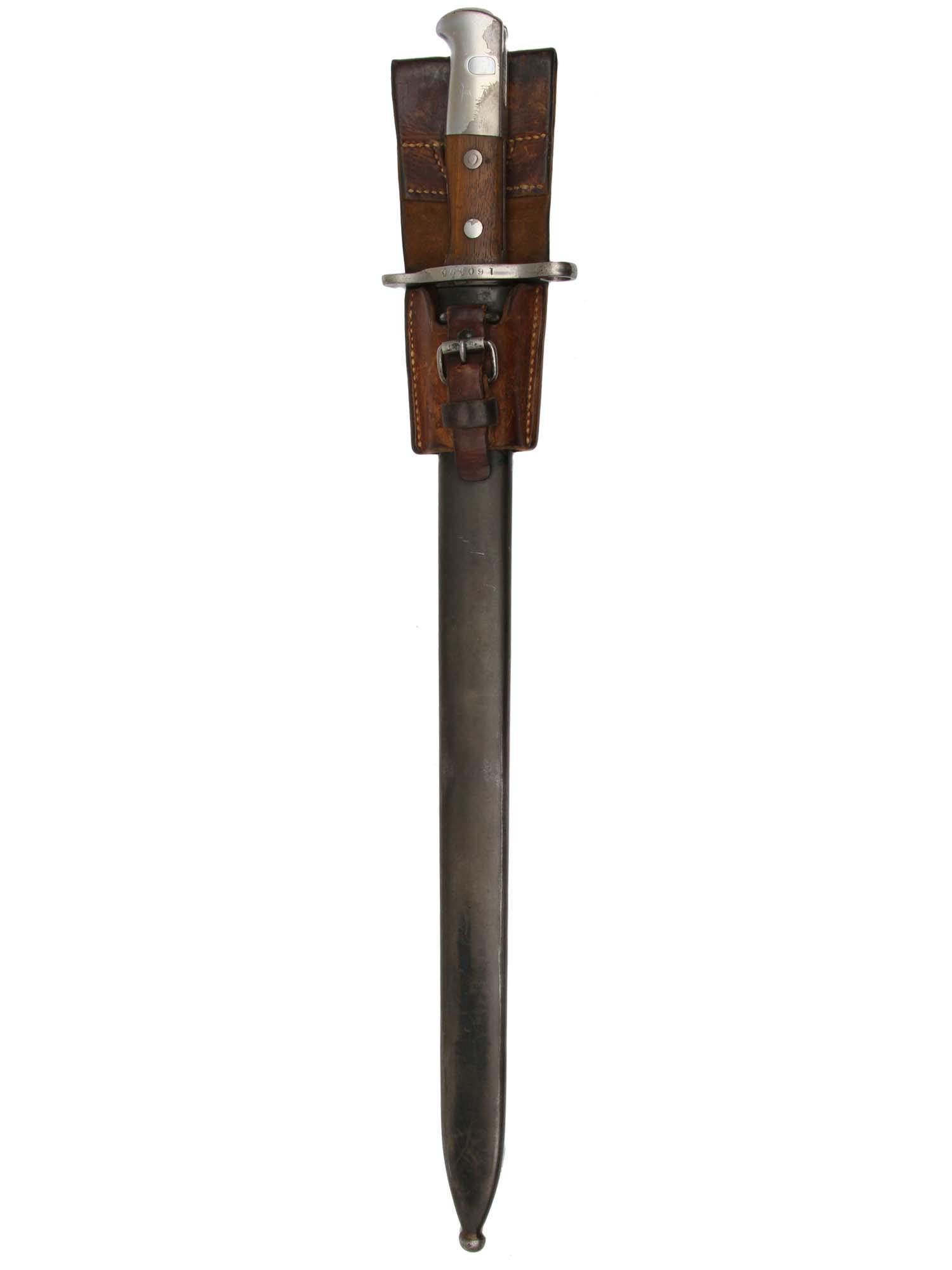 A SWISS PIONEER SAWBACK BAYONET NEUHAUSEN M1914: A bayonet for Schmidt-Rubin M1911 carbine and M1931 Short Rifle. Straight swell-point blade profile with a saw on the rib, fullered on one side, stamped "WAFFENFABRIC NEUHAUSEN" on ricasso, serial num