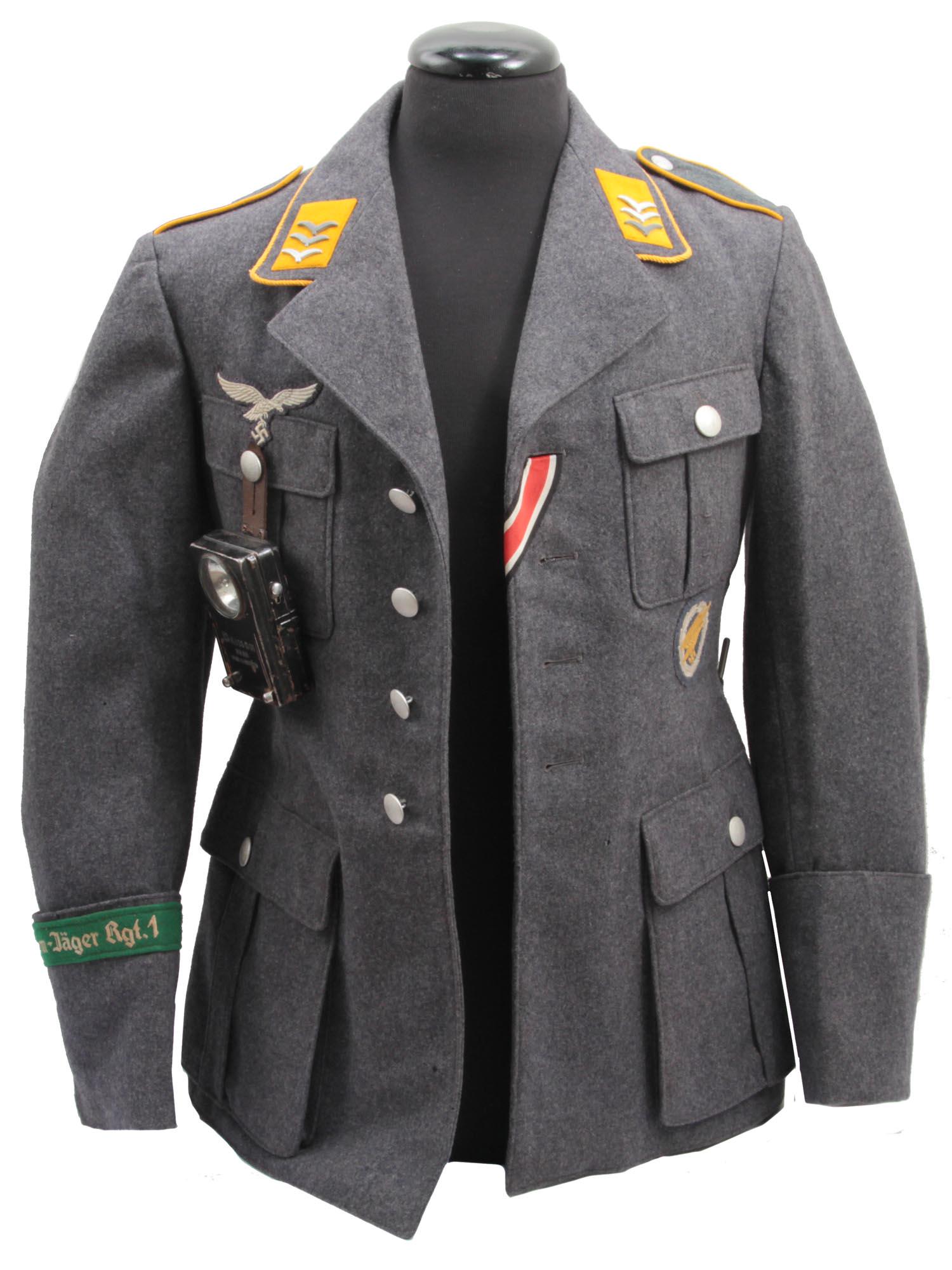 A RARE NAZI GERMANY LUFTWAFFE PARATROOPER UNIFORM: An early Luftwaffe 4-pocket Paratrooper tunic of the "Fallschirm-JÃ¤ger Rgt. 1" with cuff title on right arm. The tunic has 1938 issue markings and 7./Fallschirm-JÃ¤ger Rgt.1 plus second stamp II.