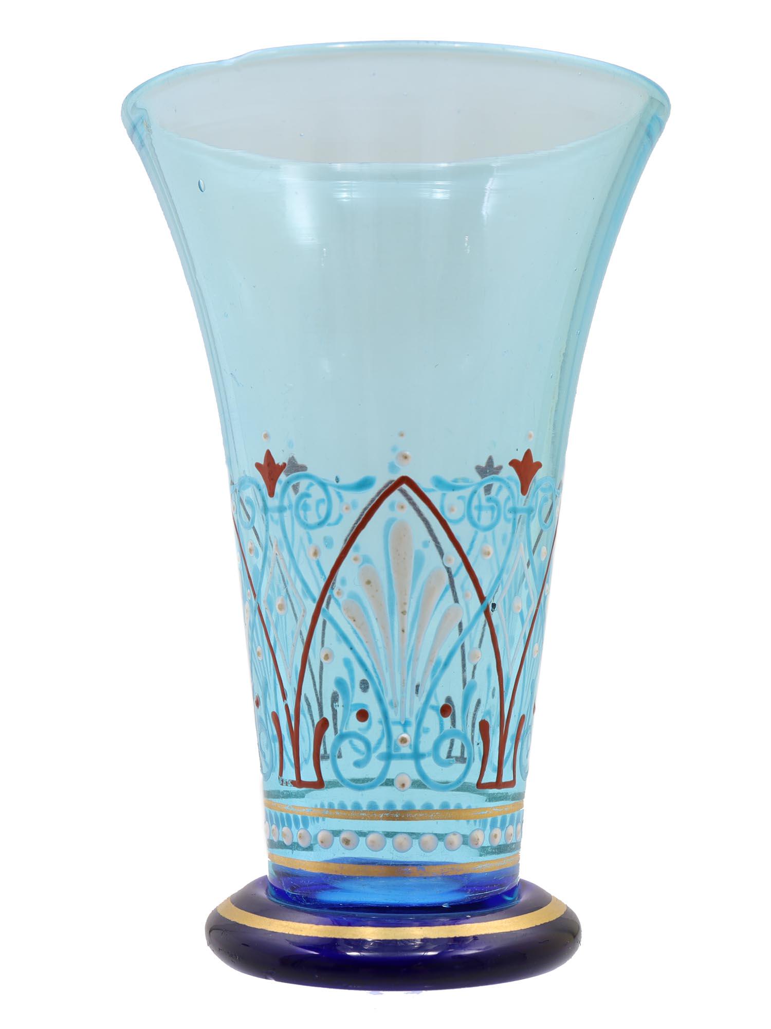 A RUSSIAN ENAMEL-PAINTED GLASS VODKA CUP, 1900: Fine antique vodka cup of blue glass, decorated with gilding and enamel patterns on the surface. At the bottom is a stamp with the monogram of Alexander III under the imperial crown. Dimensions: H: 4 