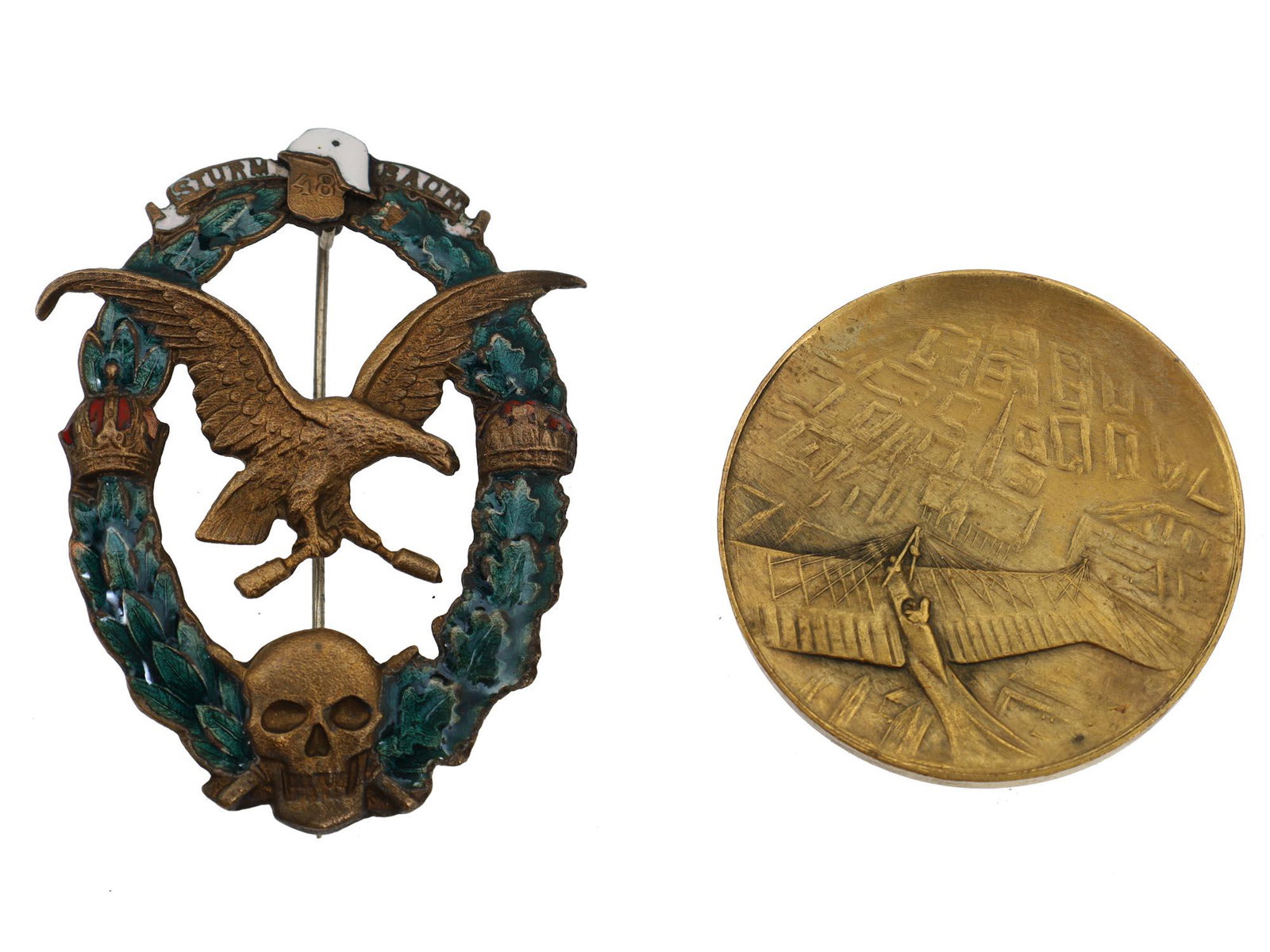 A LOT TWO AUSTRIAN WWI AND PRE-WWI BRONZE BADGES: The lot includes: 1. WWI Austrian stormtrooper bronze badge. The badge is an enameled half oak half laurel wreath with two crowns on the sides and a skull at the bottom in the center. Inside the wreat