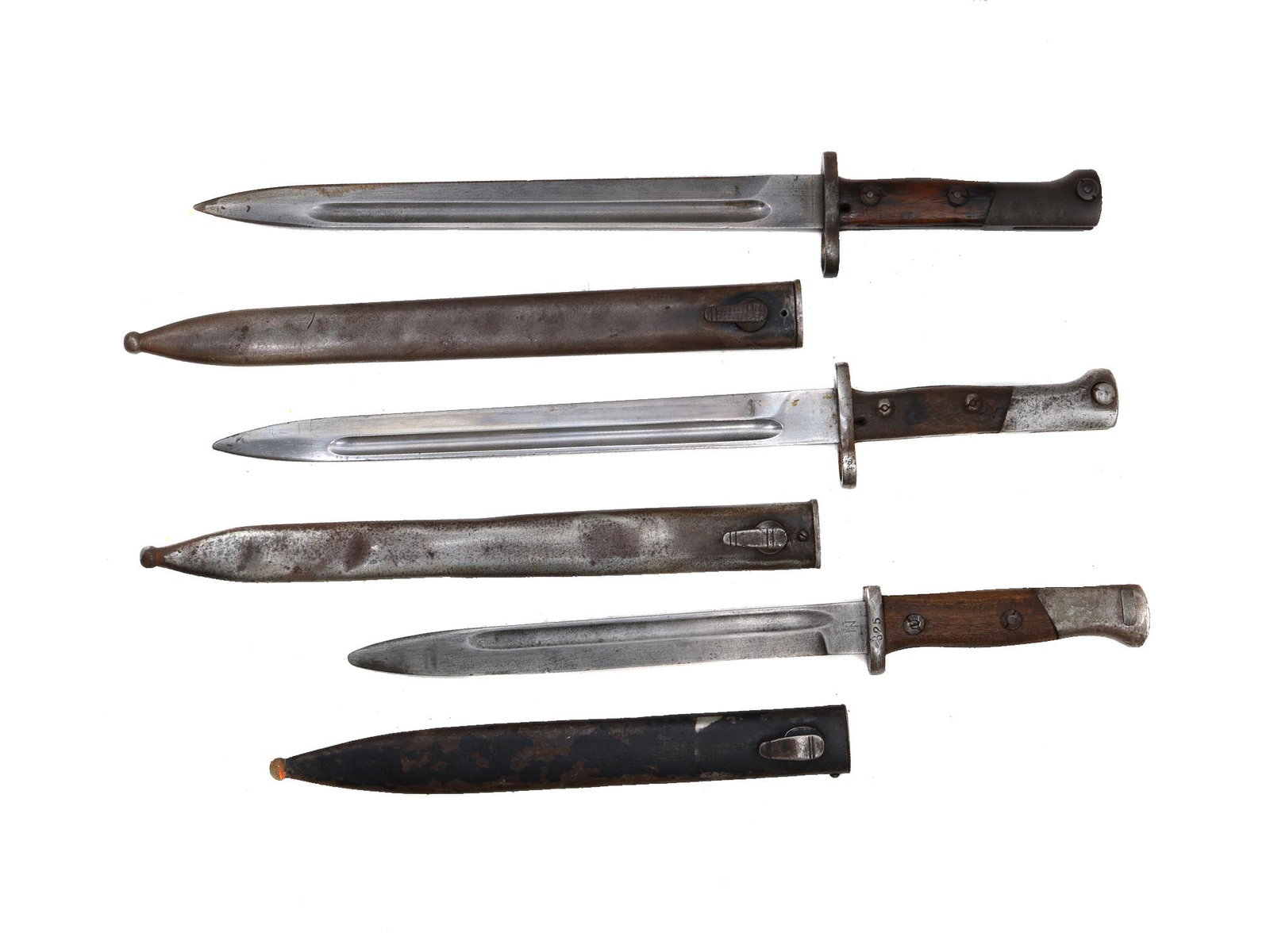 A LOT OF THREE MAUSER BAYONETS SPANISH AND YUGOSLAVIAN: Two Yugoslavian M1924 Mauser rifle bayonets and one Spanish M1944 Mauser bayonet. Bayonets bear factory and inspection markings. Dimensions: L: 18 in., (45.7 cm.)