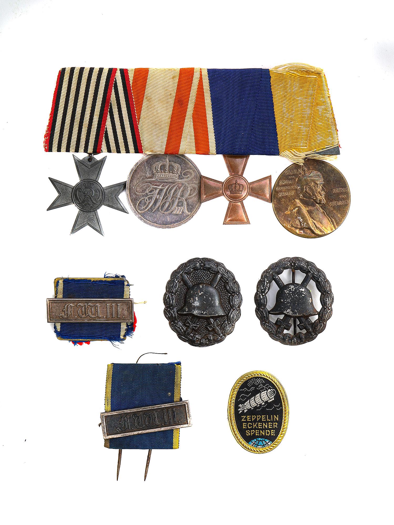 A PRUSSIAN MEDAL BAR, SPANNING FROM POST 1870 TO 1918: Prussian Medal Bar, spanning from post-1870 to 1918. WW1 Cross for Non-Combattant War Service, Silver Merit Medal, 18 Year Military Service Cross, and 1897 Centenary Medal. Plus Long Service Bar, Iron