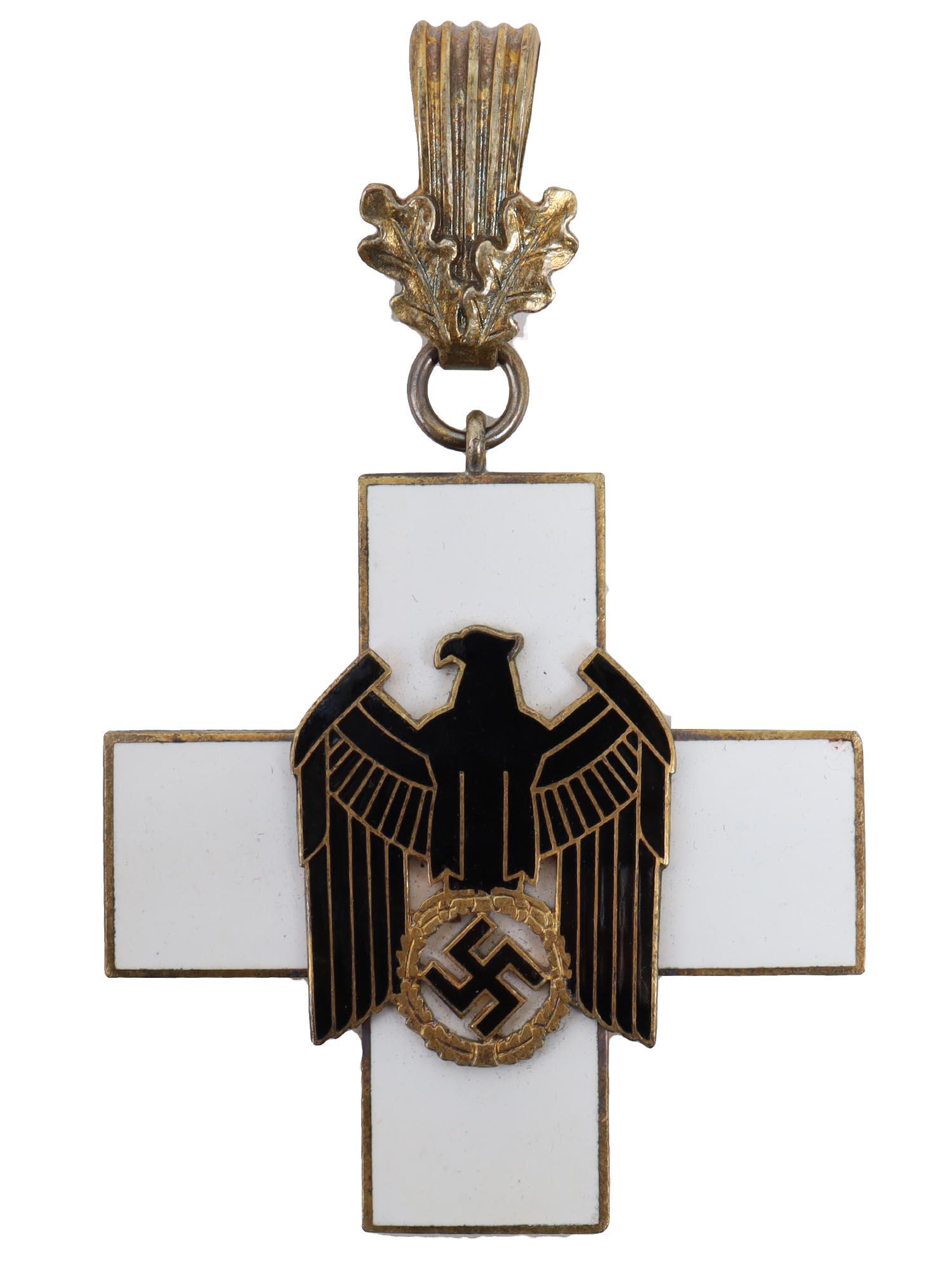 A CASED WWII GERMAN SOCIAL WELFARE 1ST CLASS ORDER: Third Reich German Social Welfare Decoration 1st Class cased Neck Cross. Gilt highlighted black enameled eagle holding a gilt wreath/gilt swastika-mounted on a white enameled neck cross. Gold suspensi