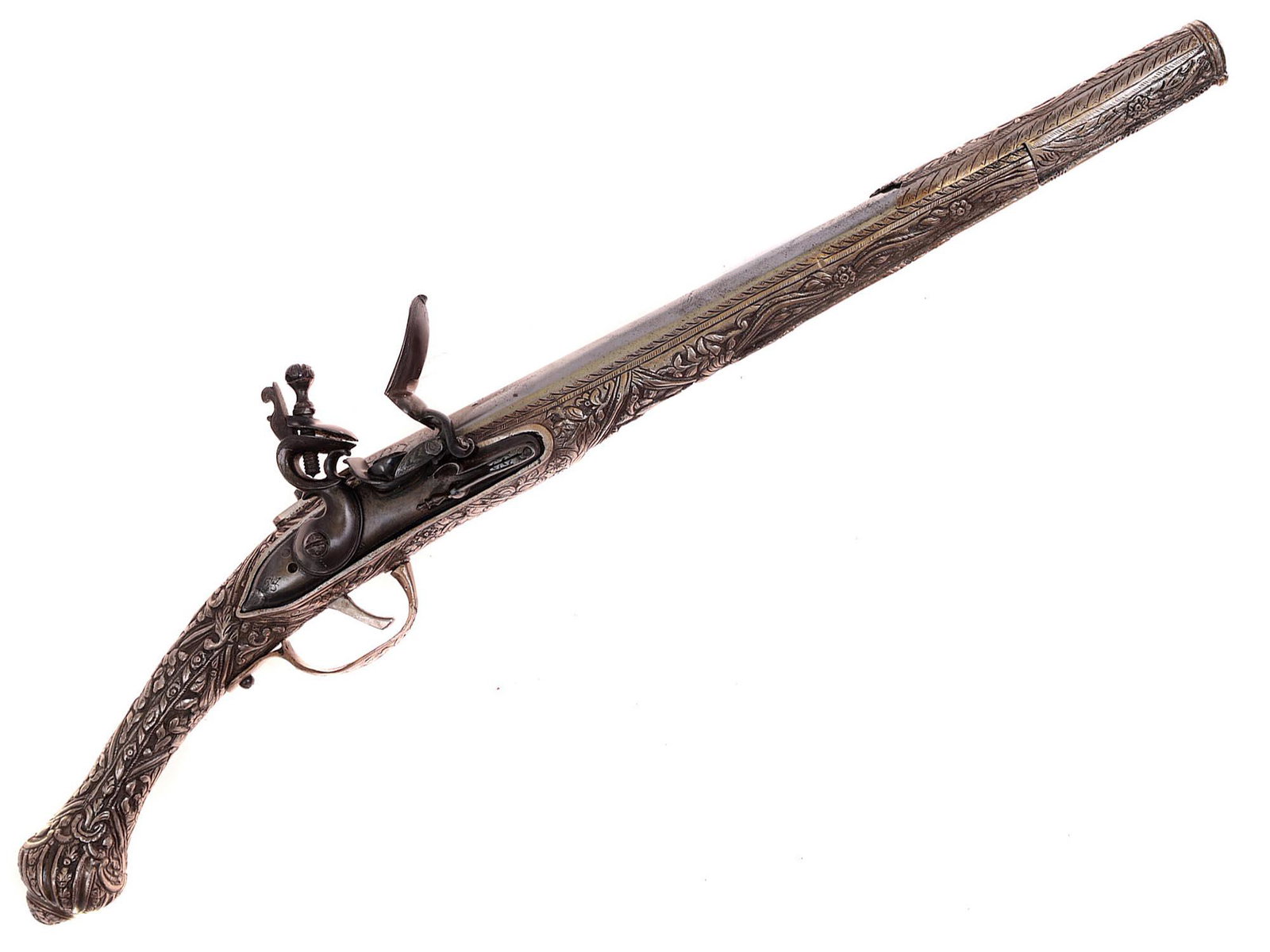 GREEK FLINTLOCK PISTOL WITH AN EMBROSSED SILVER STOCK 19 C.: A Greek or Balkan flintlock pistol with elaborately embossed silver munts. Dimensions: L: 20 7/8 in., (53 cm.)