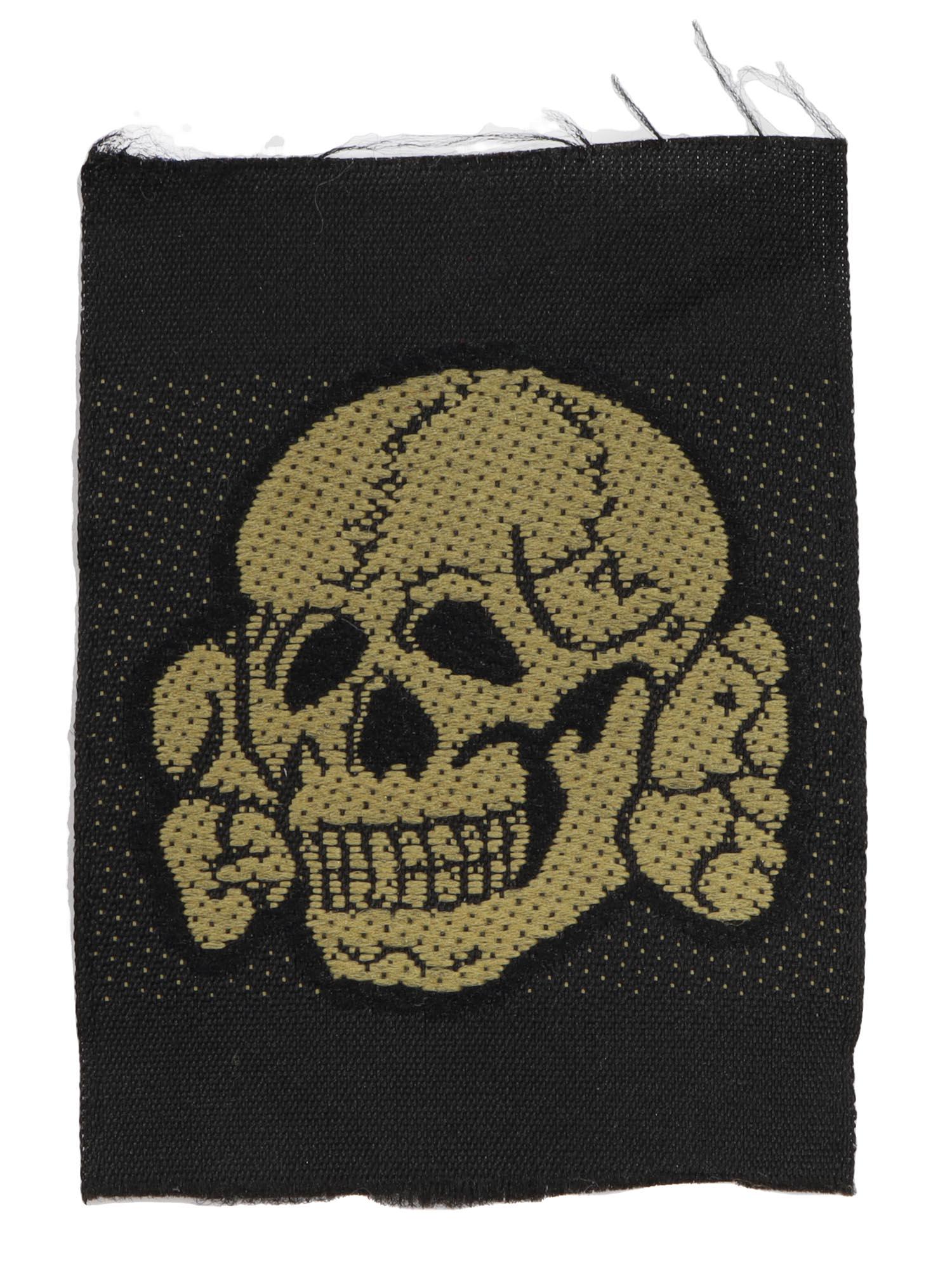 AN ORIGINAL WW2 GERMAN SS TROPICAL SKULL PATCH: A Bevo-woven yellow version for field cap Waffen-SS tropical Totenkopf cap patch/insignia. Dimensions: L: 2 3/16 in., (5.5 cm.)