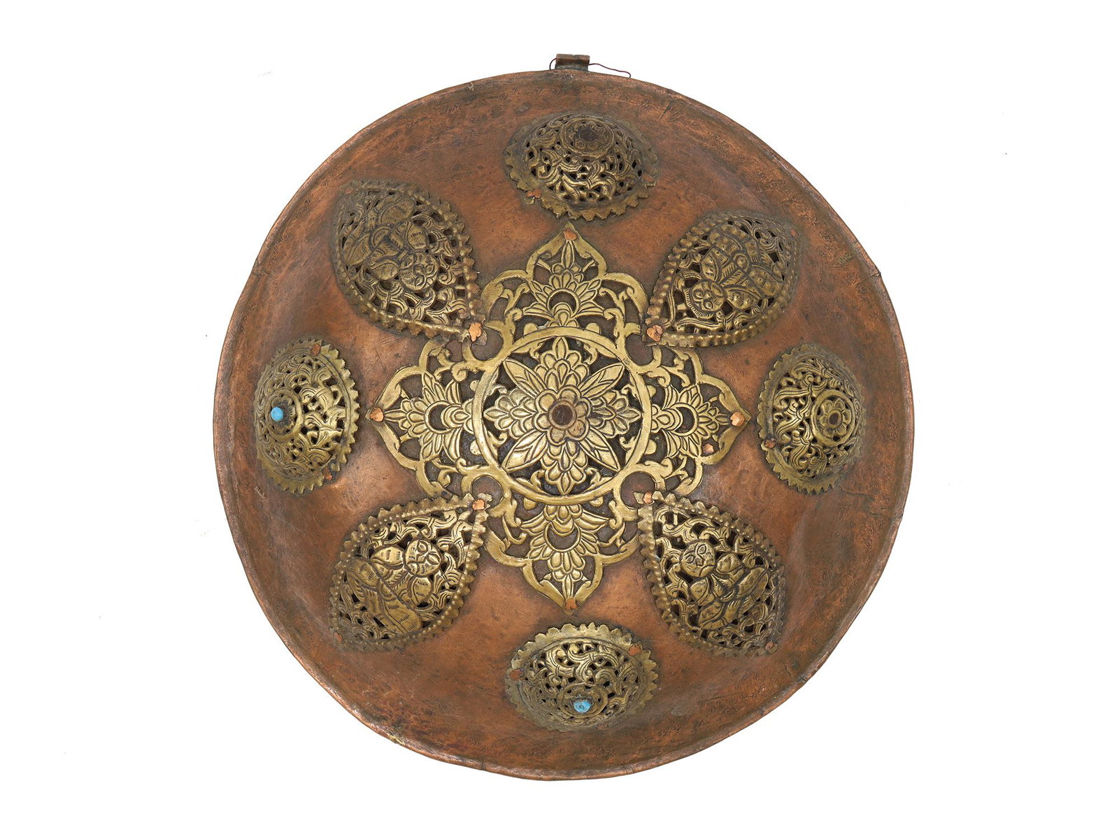A HIMALAYAN OR TIBETIAN RITUAL SHIELD, 19TH CEN.: A rare Tibetan ceremonial sheet copper shield, 19th century. Of convex circular shape, provided with a raised border. The shield is set with four domed bosses with perforated floral decoration intersp