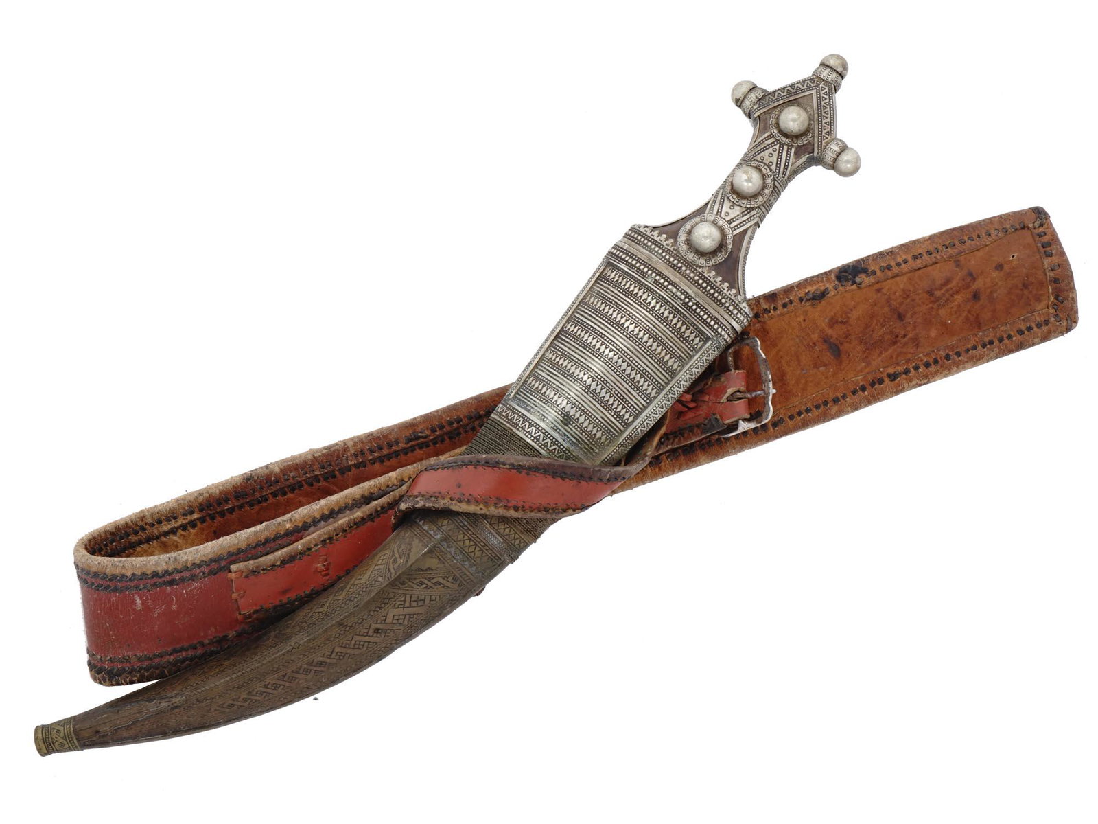A LARGE SAUDI ARABIA WAHABITE JAMBIYA IN SILVER MUNTS, 19 C: Hilt and scabbard fittings are richly decorated with silver bands, rosettes, and chiseling, the scabbard is covered with leather. The blade is double-edged with a small fuller on each side. The jambiy