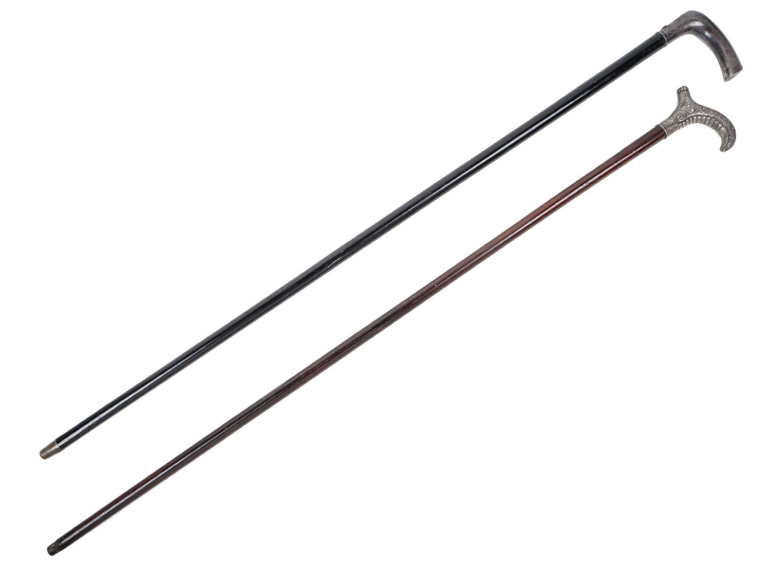 A LOT OF TWO SILVER-MOUNTED WALKING CANES: Two wood canes with silver-mounted handles. One cane features a highly detailed spider in a web and a fly, and engraved inscription "ZNAIM 12/III 07" and "SA" initials. The second cane is decorated wi