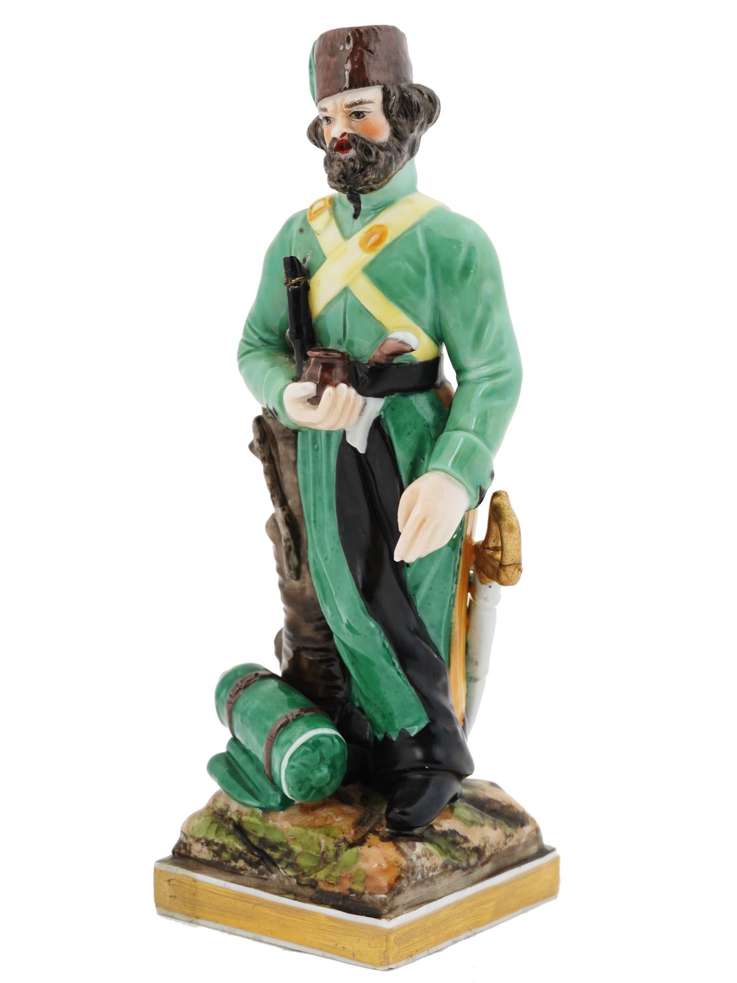 A RUSSIAN PORCELAIN FIGURINE OF A STANDING COSSACK, 19TH C. (1 of 5)