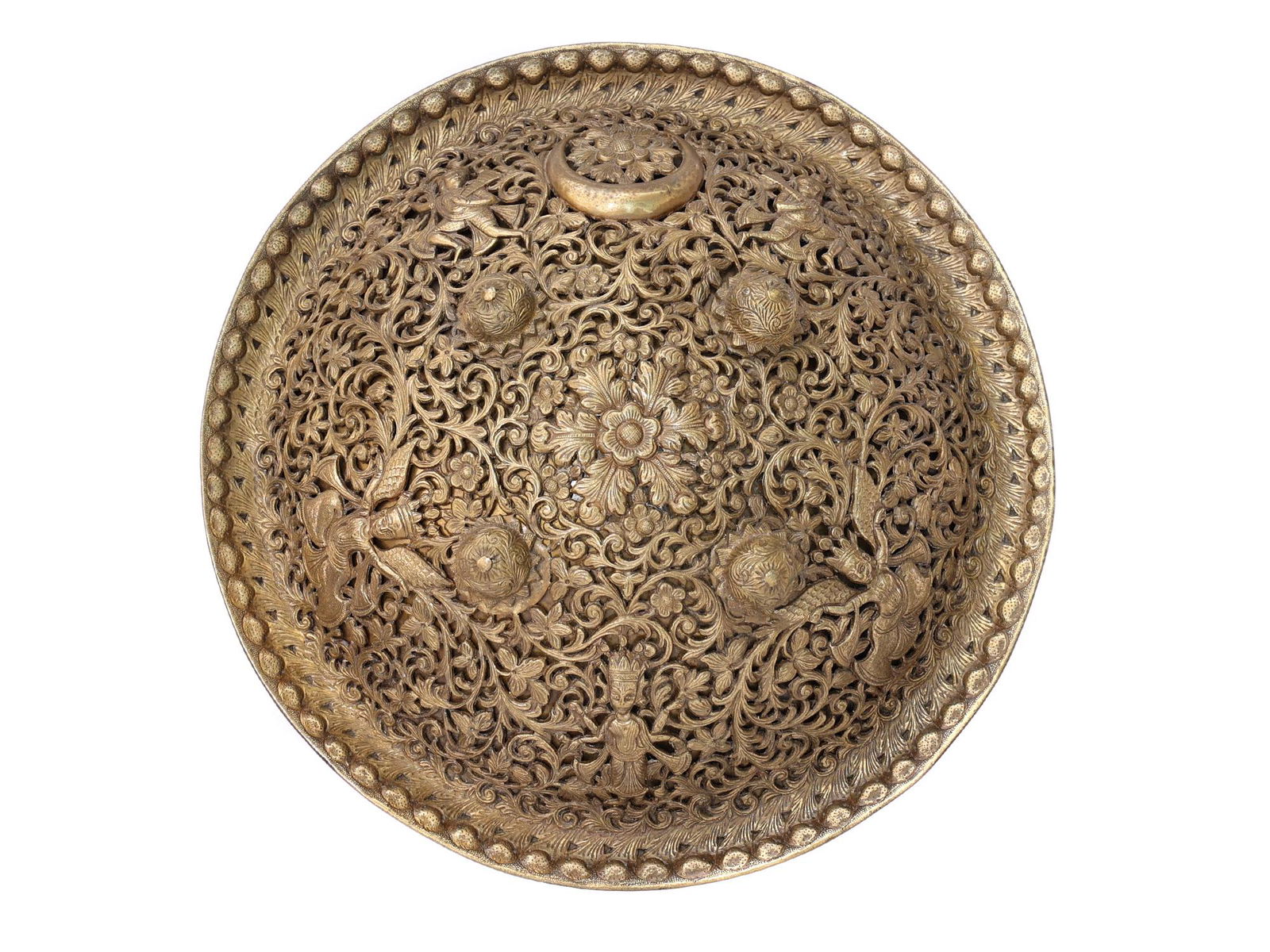 AN EXCEPTIONAL INDIAN PIERCED DHAL SHIELD, 19 C.: An openwork brass shield of a circular convex form, with applied bosses and a crescent moon, the openwork decoration comprises deities on dense swaying foliage and floral ground. The rich floral decor