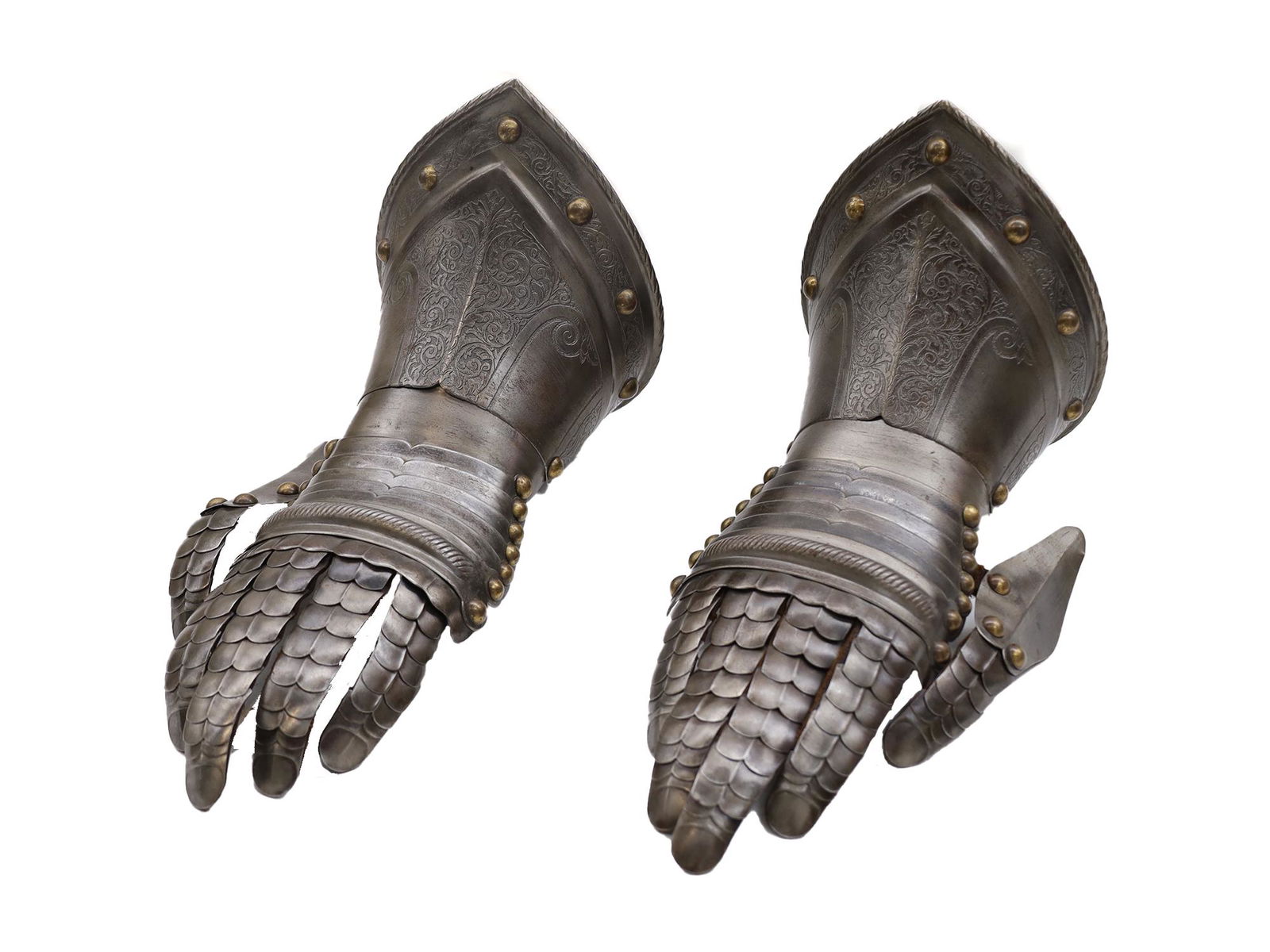 A PAIR OF SPANISH GAUNTLETS, HAND ARMOR: A fine pair of armor gauntlets, Europe, 19th century. Made of hammered steel, riveted leather articulated fingers (complete), and rolled-and-file decorated edges. The lovely engraved decoration is see