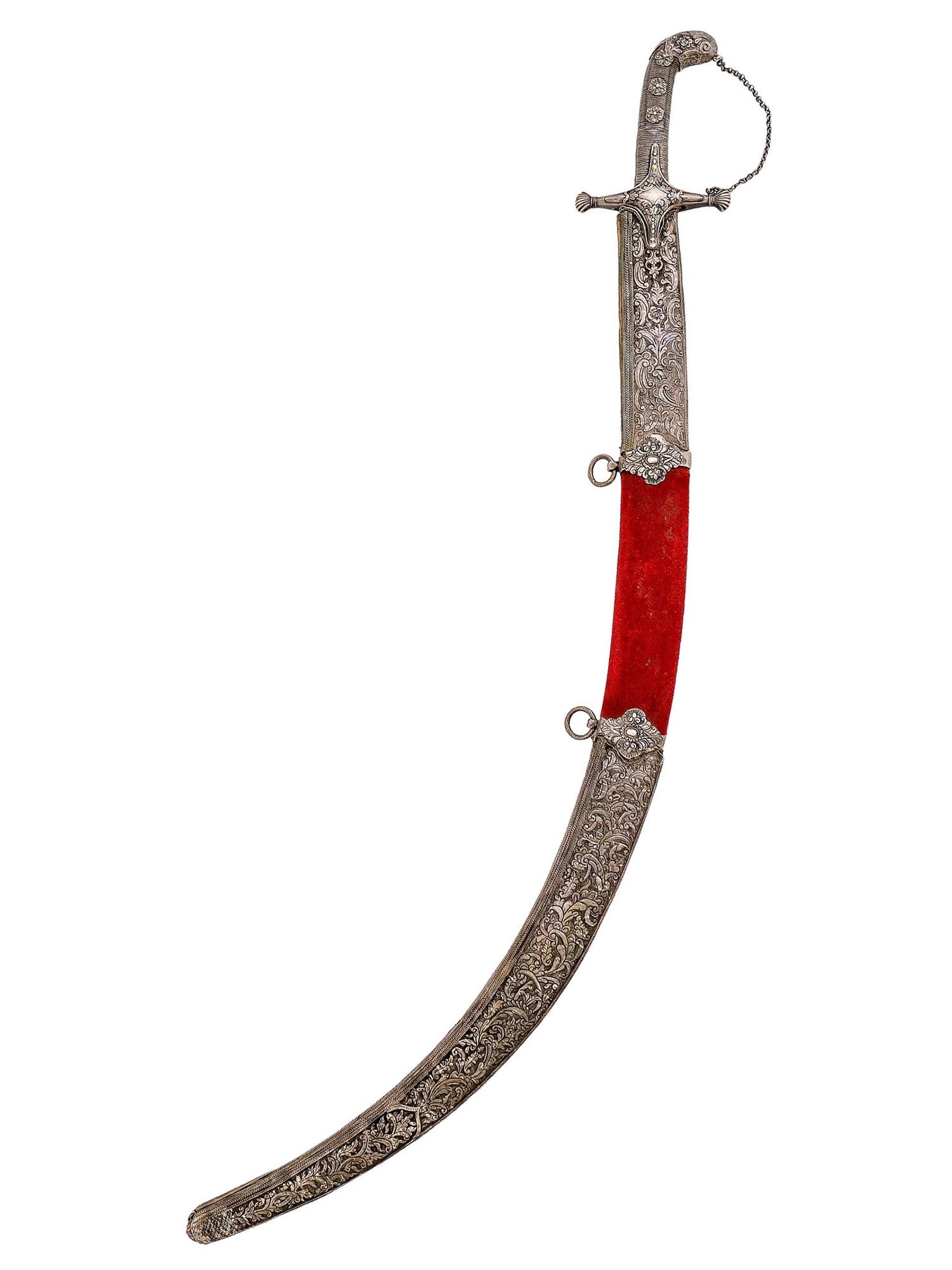 A GREEK SHAMSHIR BALKAN SABRE OTTOMAN EMPIRE WAR, 1820'S: Revolutionary Greek War period (1821 - 1829) shamshir sword with chased silver mounts equipped with two loose silver suspension rings and hilt. The blade is single-edged and curved with a pointy tip. 