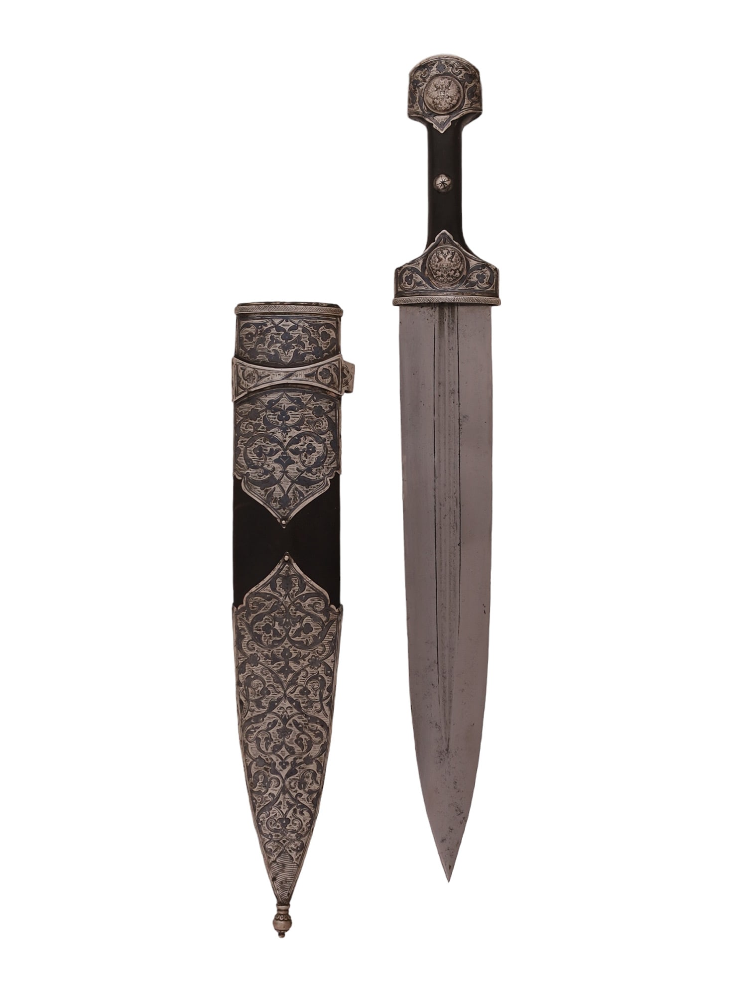 A CAUCASIAN SILVER-MOUNTED BLACK SEA KINJAL DAGGER, CA. 1880: Of a characteristic form with a wide double-edged blade with two narrow fullers on both sides. The grip is made of a polished horn fastened to the tang by three steel rivets with silver caps. The scab