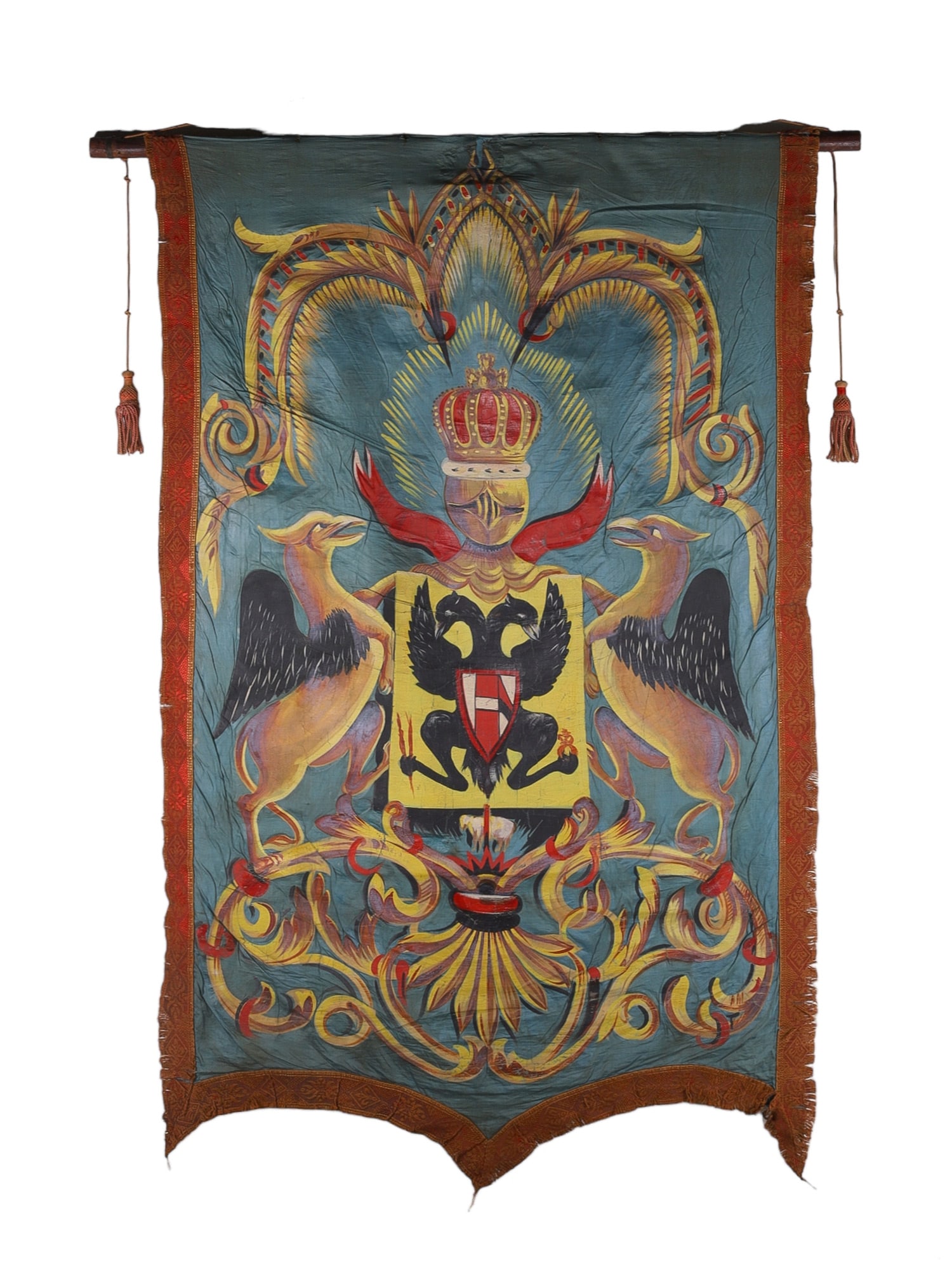 A BANNER WITH AUSTRIAN HERALDRY, MID 19TH C.: The banner is of cloth with embroidered edges and a stylized painted depiction of the coat of arms of Austria-Hungary supported by two griffins and surmounted by a crest consisting of a helmet topped 